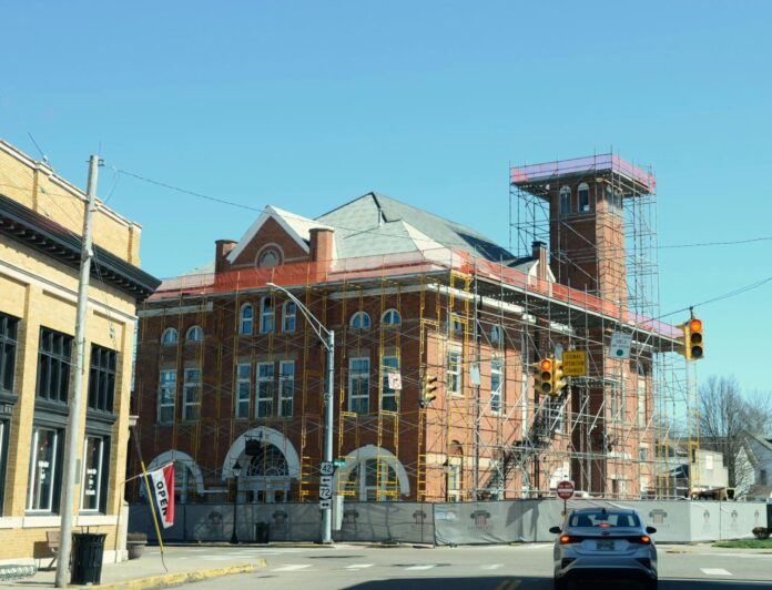 Brick building with scaffolding under clear sky