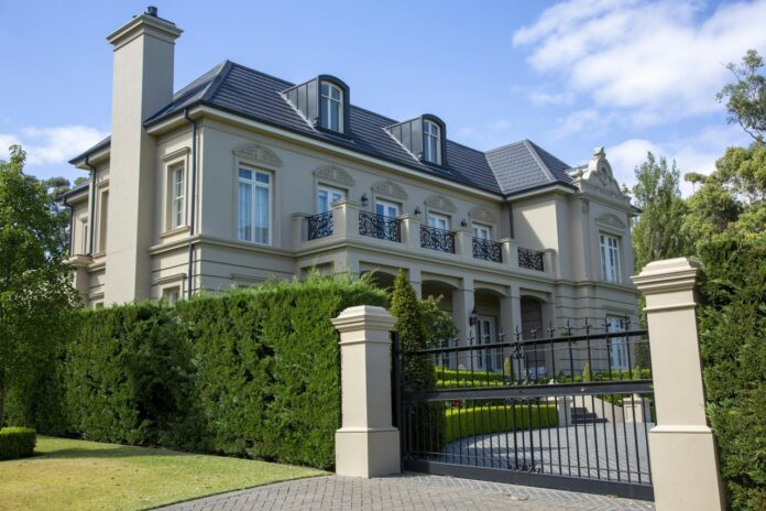 a large house with a black iron gate in front of it