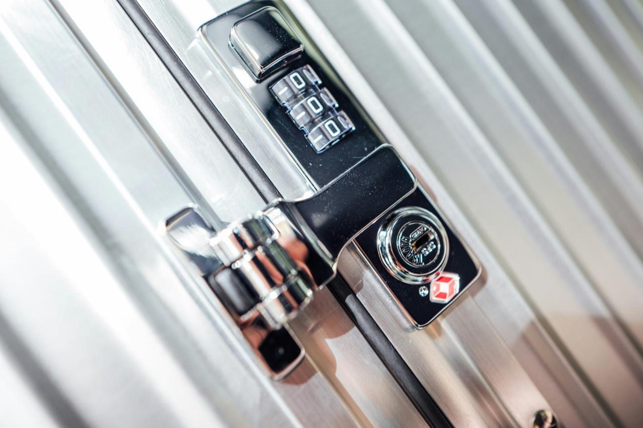 a close up of a metal door handle with a clock on it