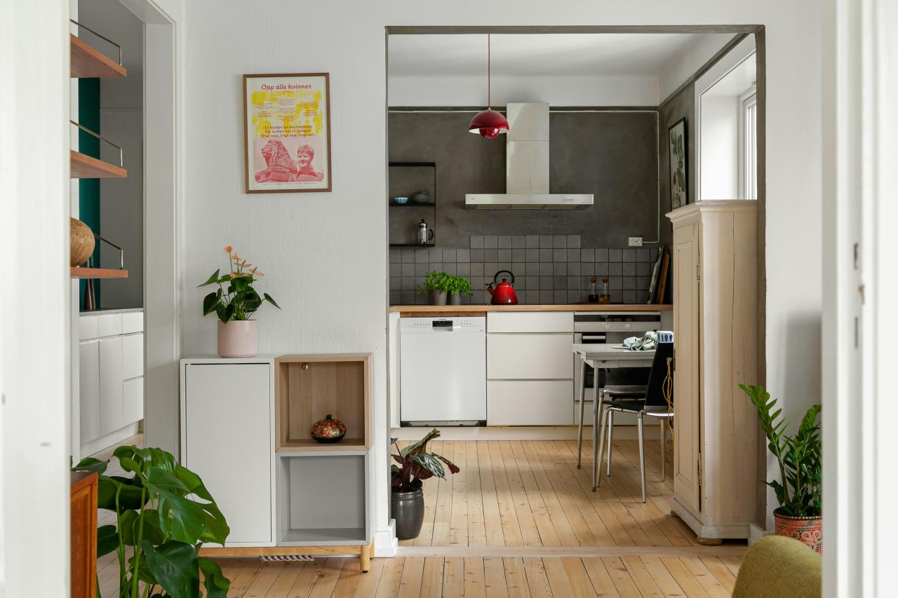 A living room with a kitchen and dining area