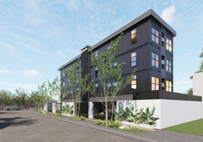 Modern dark building with trees and white base.